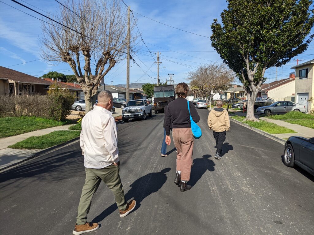 People walking on a street in a residential neighborhood
