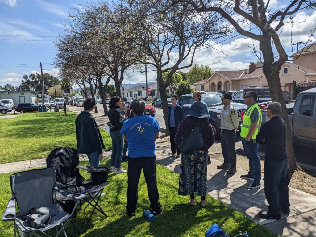 A group of people in a circle in a residential neighborhood