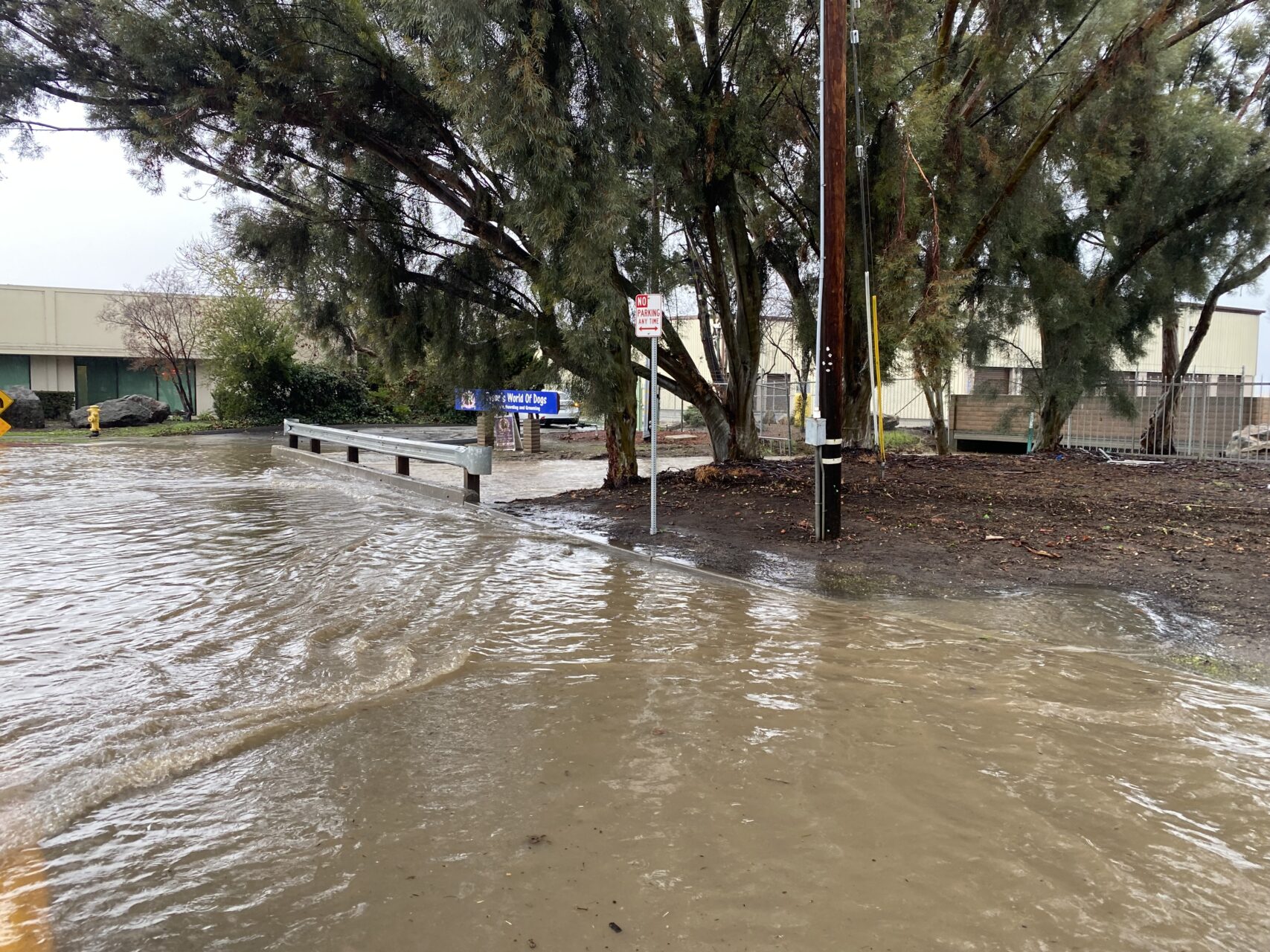 A street is filled with muddy flood water