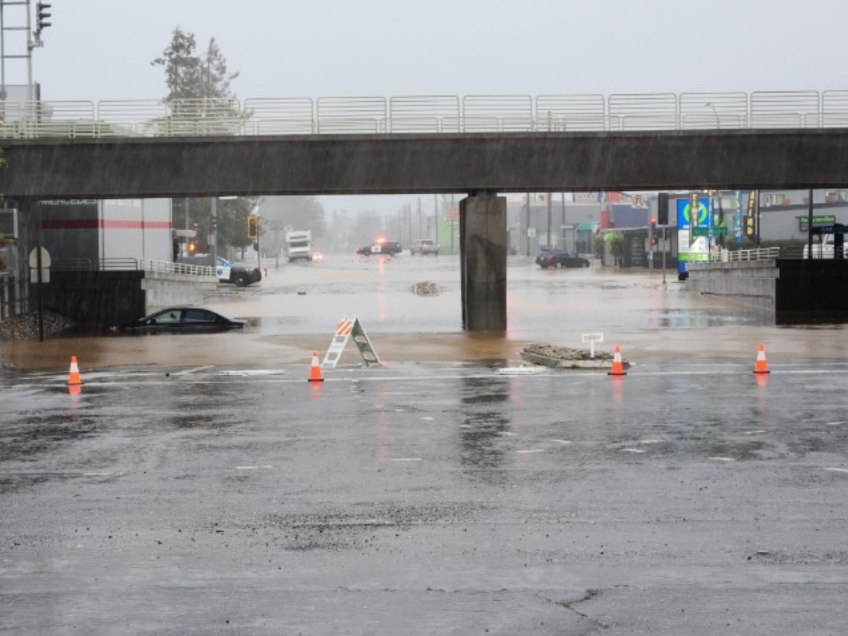A flooded street with a submerged car