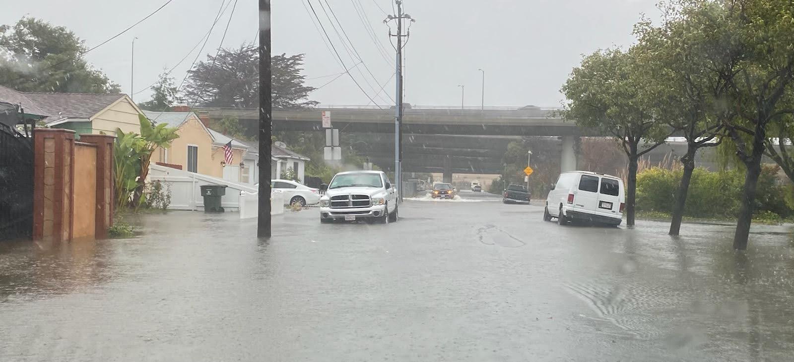 A flooded street in a residential neighborhood