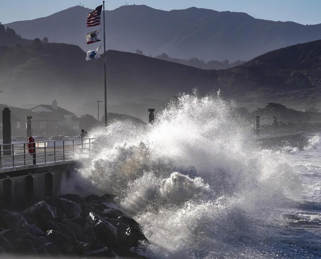 Powerful waves crash against the Pacific Pier